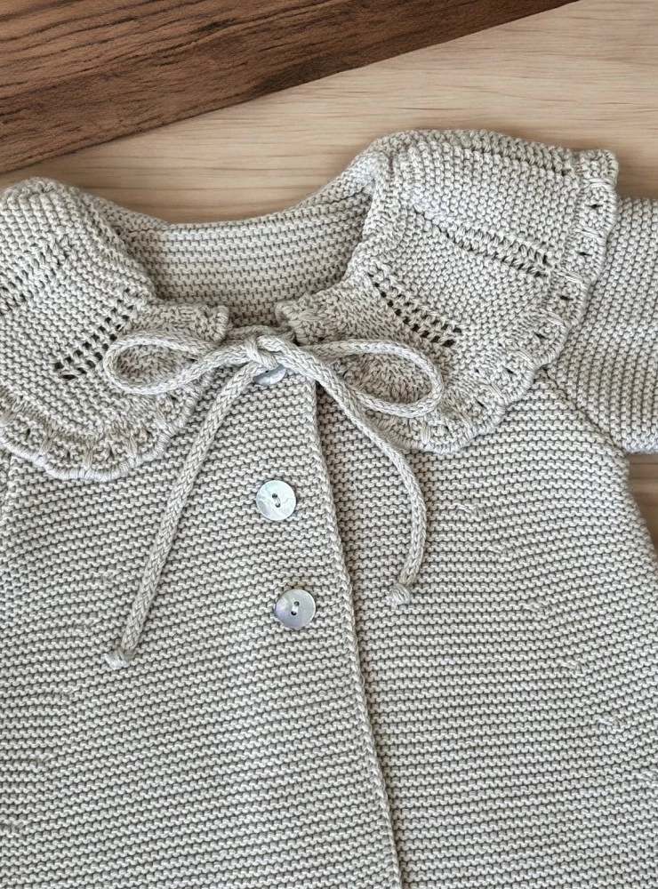 A-line coat in beige or sand color knit. Special ceremony or dress