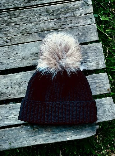 English knit hat with natural fur pompom.